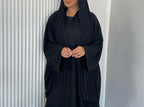 A Stylish, Loose-fitting Long Cardigan With Wavy Trim, Paired With Two Headscarves.