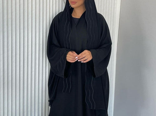 A Stylish, Loose-fitting Long Cardigan With Wavy Trim, Paired With Two Headscarves.