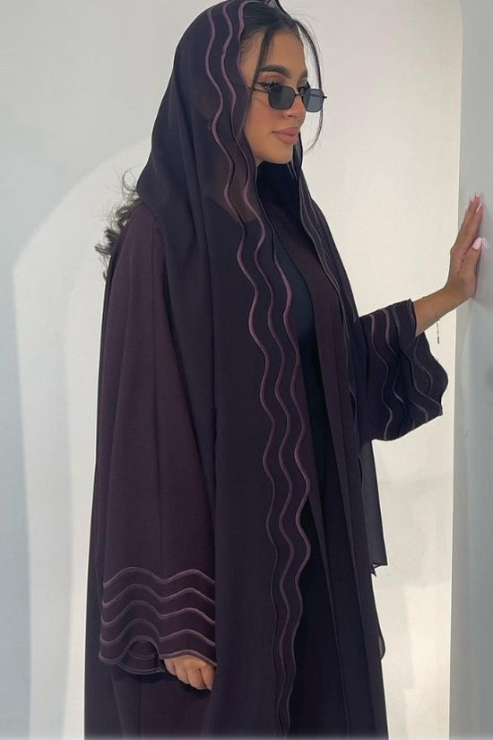 A Stylish, Loose-fitting Long Cardigan With Wavy Trim, Paired With Two Headscarves.