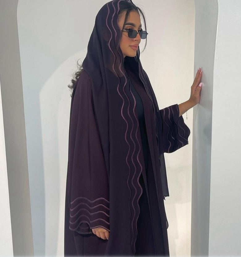 A Stylish, Loose-fitting Long Cardigan With Wavy Trim, Paired With Two Headscarves.