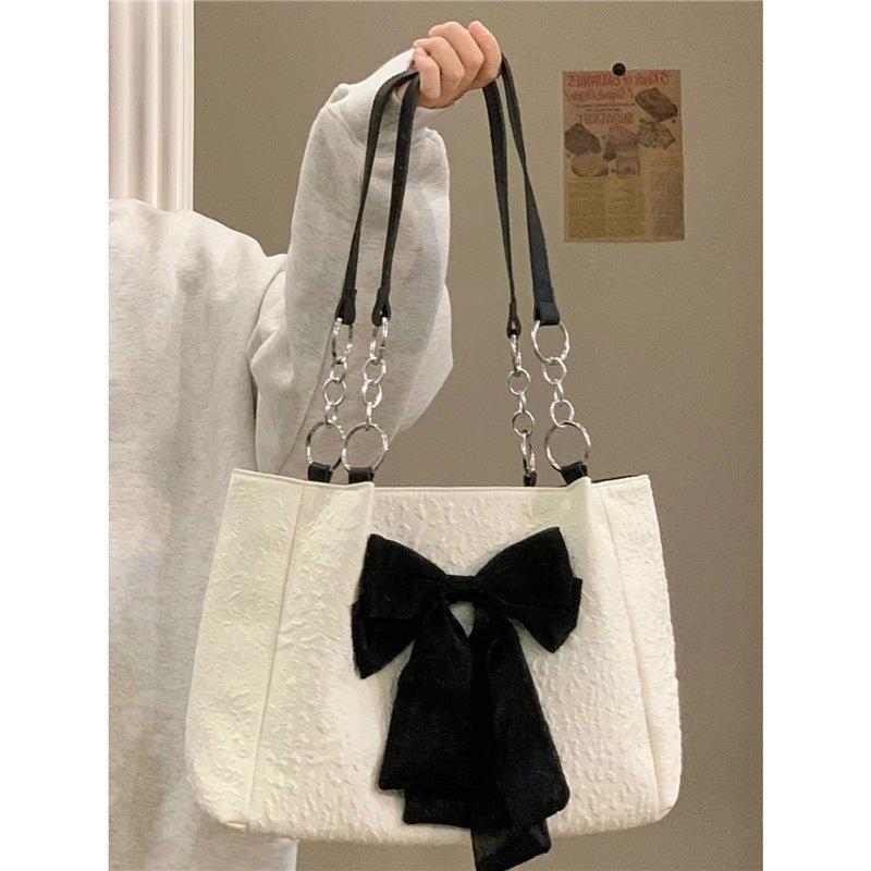 Bow Tote Large Capacity Canvas Shoulder Bag $29.77 Dana Fashion Color: White Women's Bags Product information: Lining texture: canvas Color: White Hardness: soft Material: Polyester Number of shoulder straps: Single Size: length 34, height 24, width 10CM