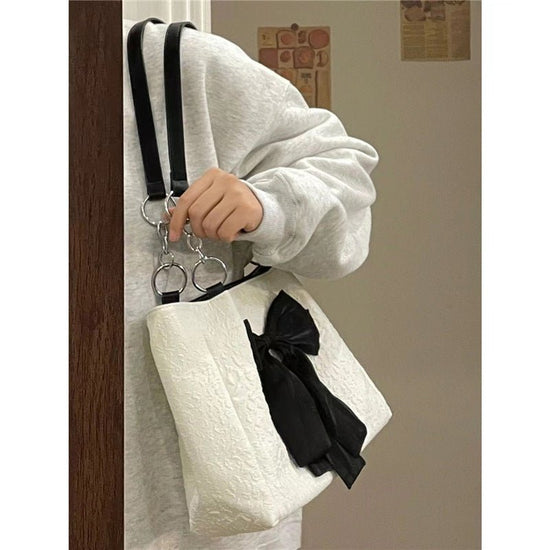 Bow Tote Large Capacity Canvas Shoulder Bag $29.77 Dana Fashion Color: White Women's Bags Product information: Lining texture: canvas Color: White Hardness: soft Material: Polyester Number of shoulder straps: Single Size: length 34, height 24, width 10CM