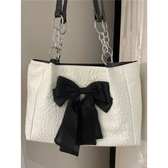 Bow Tote Large Capacity Canvas Shoulder Bag $29.77 Dana Fashion Color: White Women's Bags Product information: Lining texture: canvas Color: White Hardness: soft Material: Polyester Number of shoulder straps: Single Size: length 34, height 24, width 10CM