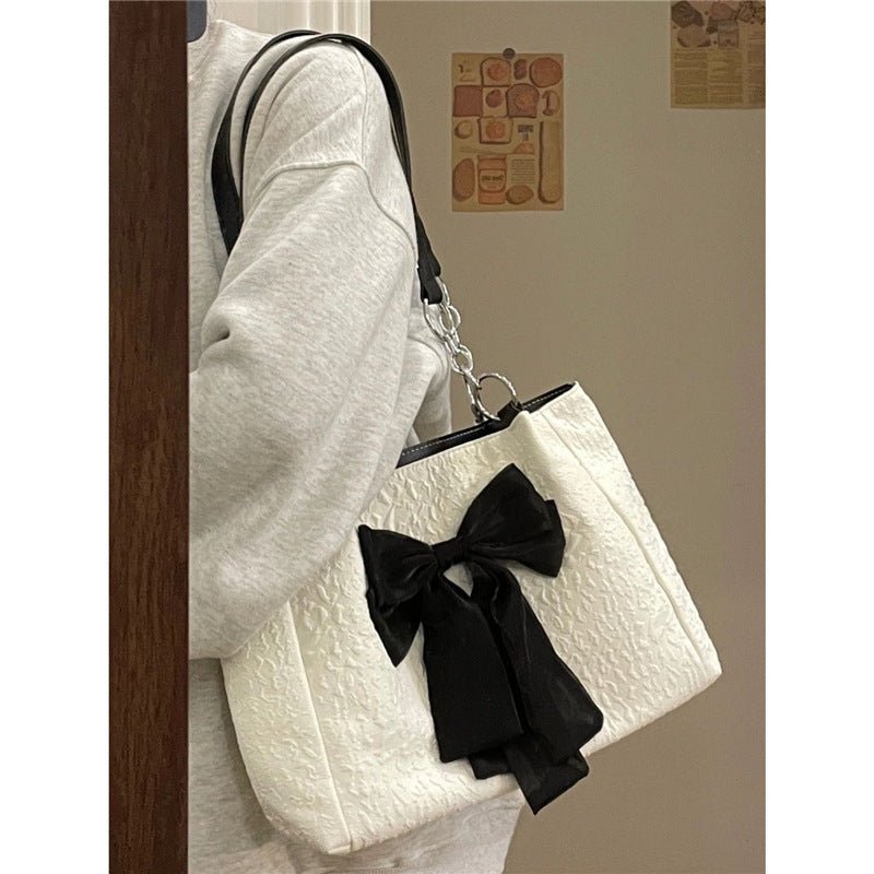 Bow Tote Large Capacity Canvas Shoulder Bag $29.77 Dana Fashion Color: White Women's Bags Product information: Lining texture: canvas Color: White Hardness: soft Material: Polyester Number of shoulder straps: Single Size: length 34, height 24, width 10CM