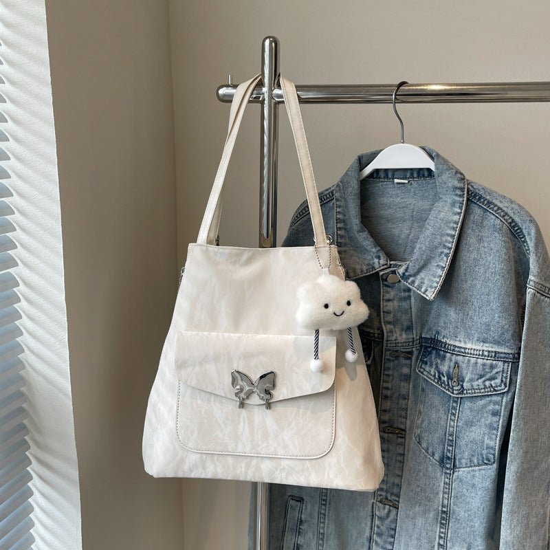 Cartoon Casual Solid Color Leather Shoulder Bag $29.31 Dana Fashion Color: Beige Size: With Pendant Women's Bags Product information: Lining texture: synthetic leather Color: black, cream white, blue, silver, pink Outer bag type: Pocket Sandwich Hardness: