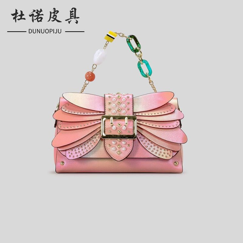 Contrast Color Heavy Industry Manual Rivet Butterfly Wings Handbag $99.00 Dana Fashion Color: Pink Women's Bags Product information: Applicable scenario: leisure travel Color: pink, purple Outer bag type: open pocket Hardness: medium hard Material: PU Sui