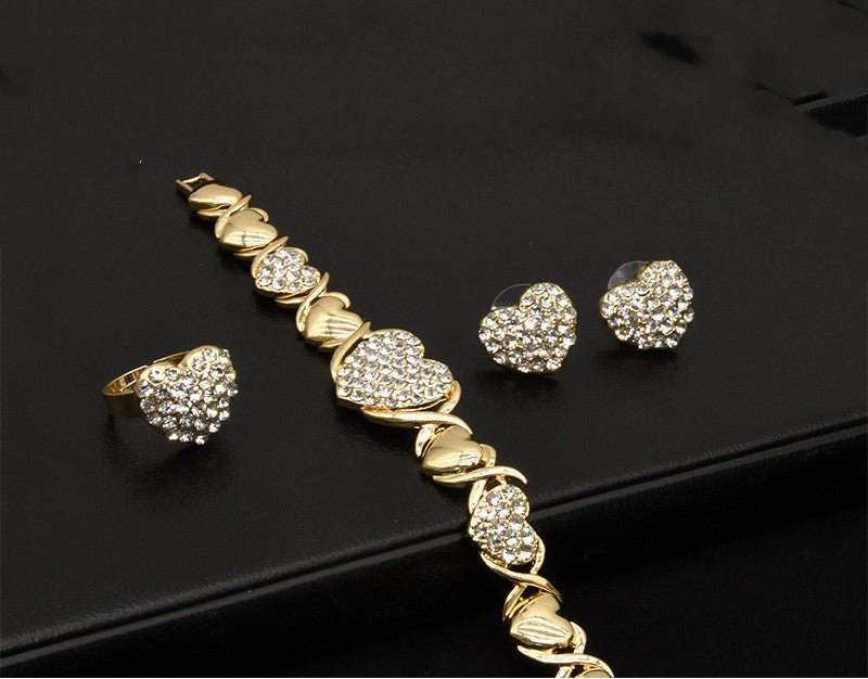 Dubai 18K Gold Heart-shaped Jewelry Suit $59.00 Dana Fashion Color: X12 Light Gold Women's Accessories Product information: Pattern: as shown in the figure Treatment Process: Electroplating Chain style: water wave chain Material: Alloy Applicable people: