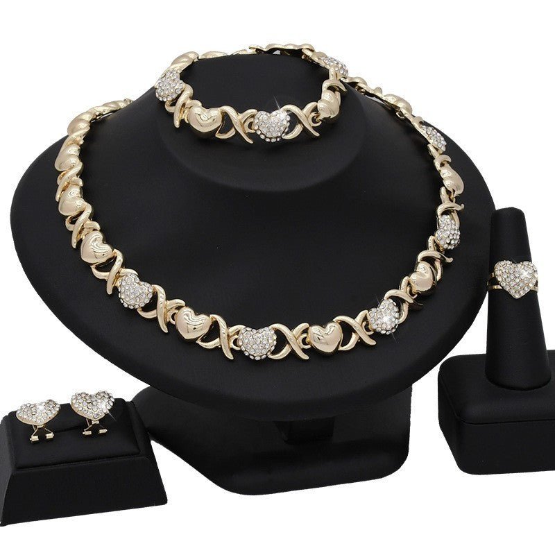 Dubai 18K Gold Heart-shaped Jewelry Suit $59.00 Dana Fashion Color: X12 Light Gold Women's Accessories Product information: Pattern: as shown in the figure Treatment Process: Electroplating Chain style: water wave chain Material: Alloy Applicable people: