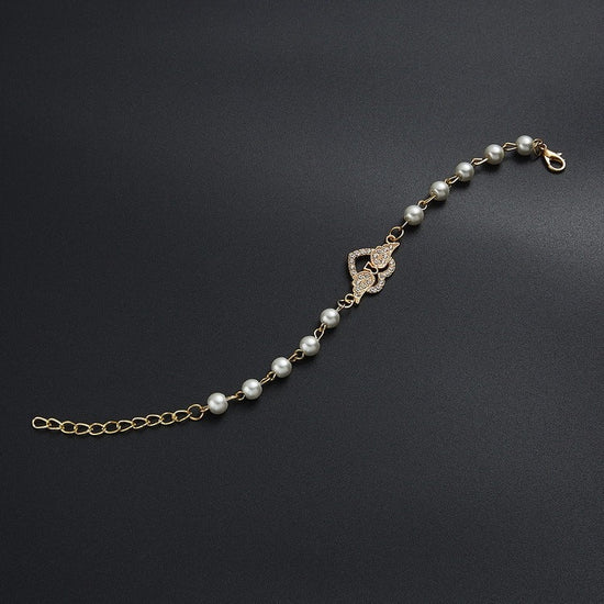 Hollow Rhinestone Pearl Bracelet Multi-style Adjustable $8.50 Dana Fashion Color: 8 Eyes Rhinestone Women's Accessories Product information: Treatment Process: Pearl Inlay Color: Cross, 8 words round, Moon XINGX, starfish, butterfly, heart-shaped wings, 8