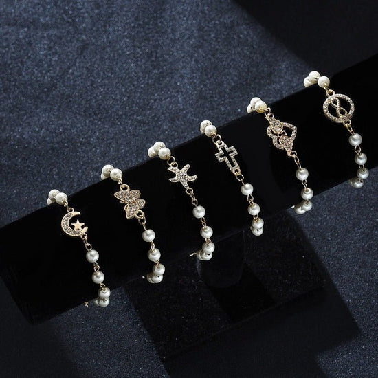Hollow Rhinestone Pearl Bracelet Multi-style Adjustable $8.50 Dana Fashion Color: 8 Eyes Rhinestone Women's Accessories Product information: Treatment Process: Pearl Inlay Color: Cross, 8 words round, Moon XINGX, starfish, butterfly, heart-shaped wings, 8