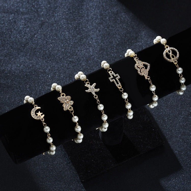 Hollow Rhinestone Pearl Bracelet Multi-style Adjustable $8.50 Dana Fashion Color: 8 Eyes Rhinestone Women's Accessories Product information: Treatment Process: Pearl Inlay Color: Cross, 8 words round, Moon XINGX, starfish, butterfly, heart-shaped wings, 8