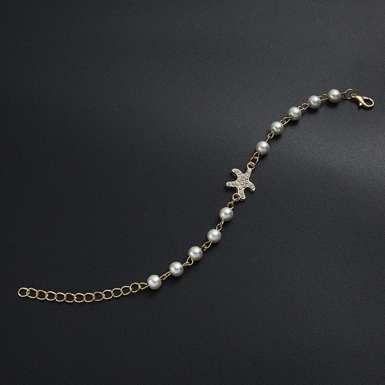 Hollow Rhinestone Pearl Bracelet Multi-style Adjustable $8.50 Dana Fashion Color: 8 Eyes Rhinestone Women's Accessories Product information: Treatment Process: Pearl Inlay Color: Cross, 8 words round, Moon XINGX, starfish, butterfly, heart-shaped wings, 8