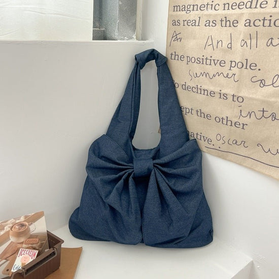 Large Capacity Bow Shoulder Underarm Tote Bag Washed Denim Canvas Bag $44.34 Dana Fashion Color: Dark Blue Women's Bags Product information: Lining texture: polyester cotton Applicable scenario: Daily configuration Color: black, blue, Milky White, dark bl
