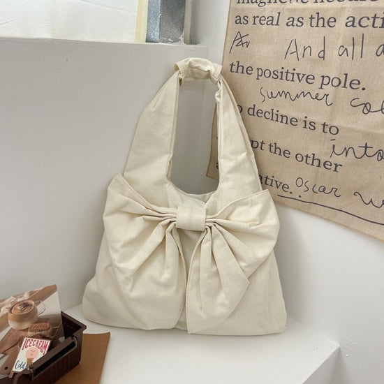 Large Capacity Bow Shoulder Underarm Tote Bag Washed Denim Canvas Bag $44.34 Dana Fashion Color: Beige Women's Bags Product information: Lining texture: polyester cotton Applicable scenario: Daily configuration Color: black, blue, Milky White, dark blue O