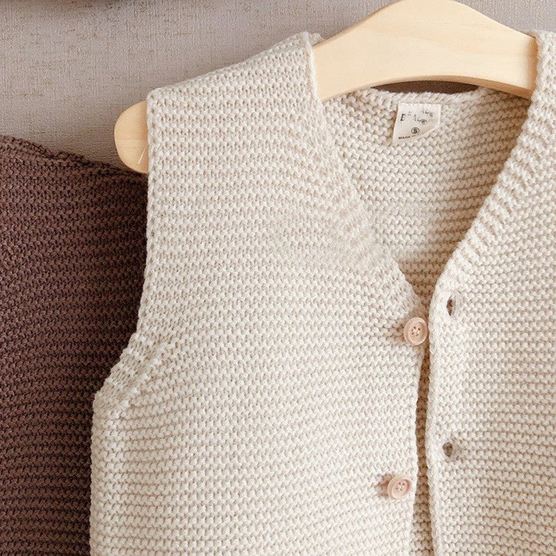 Men's And Women's Solid Color Knitted Base Vest Cardigan $24.89 Dana Fashion Color: off white Child size: 100cm Baby Clothing Product Information: Yarn thickness: fine wool Thickness: General Sleeve length: long sleeve Closed style: single-breasted Patter