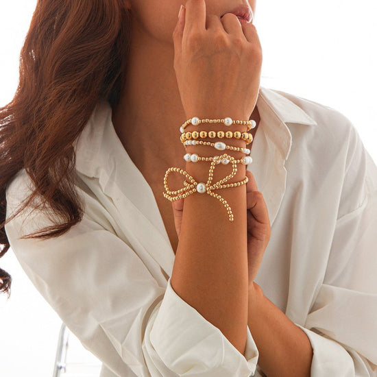 Personalized Bow Beaded Multi-layer Bracelet 5-piece Set $15.84 Dana Fashion Color: 01 Gold Women's Accessories Product information: Treatment Process: Electroplating Color: 01 Gold 5159 Applicable people: women Applicable occasions for gifts: travel comm