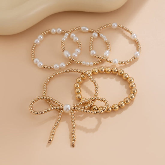 Personalized Bow Beaded Multi-layer Bracelet 5-piece Set $15.84 Dana Fashion Color: 01 Gold Women's Accessories Product information: Treatment Process: Electroplating Color: 01 Gold 5159 Applicable people: women Applicable occasions for gifts: travel comm