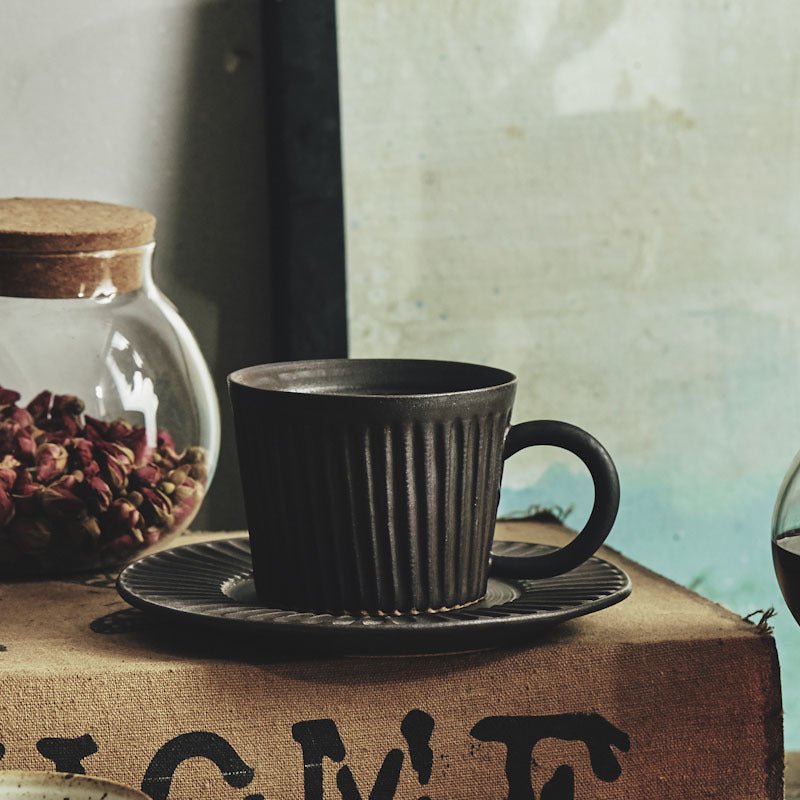 Playthings Japanese Single Product Coffee Cup With Saucer, Stoneware Stripes $37.49 Dana Fashion Color: Carbon black Dana's Kitchen Product Information: Material: pottery Style: Japanese Popular elements: retro style Color classification: Fog white, sligh