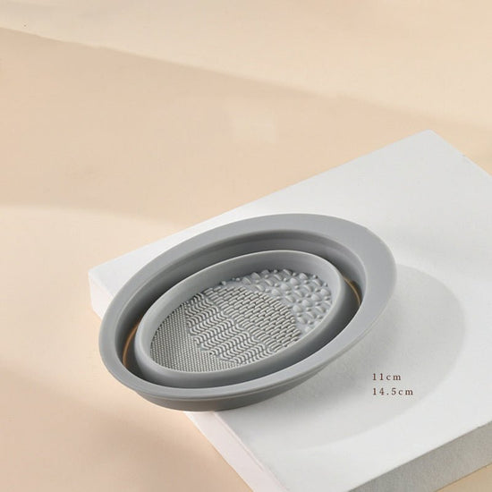 Scrubbing Plate Makeup Brush Cleaning Pad Makeup Brush Cleaning Bowl $24.00 Dana Fashion Color: Grey makeup Product Information Name: Makeup brush folding cleaning bowl Material: Silicone Be applicable: DIY facial mask Brewing water film Soaking beauty eg