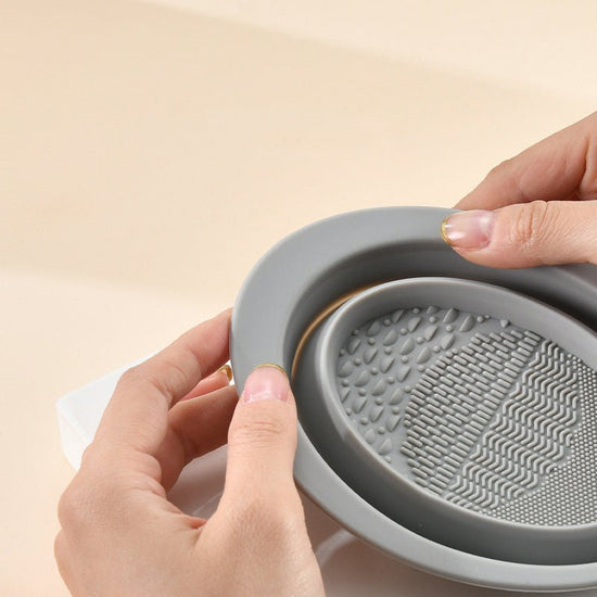 Scrubbing Plate Makeup Brush Cleaning Pad Makeup Brush Cleaning Bowl $24.00 Dana Fashion Color: Dark Purple makeup Product Information Name: Makeup brush folding cleaning bowl Material: Silicone Be applicable: DIY facial mask Brewing water film Soaking be
