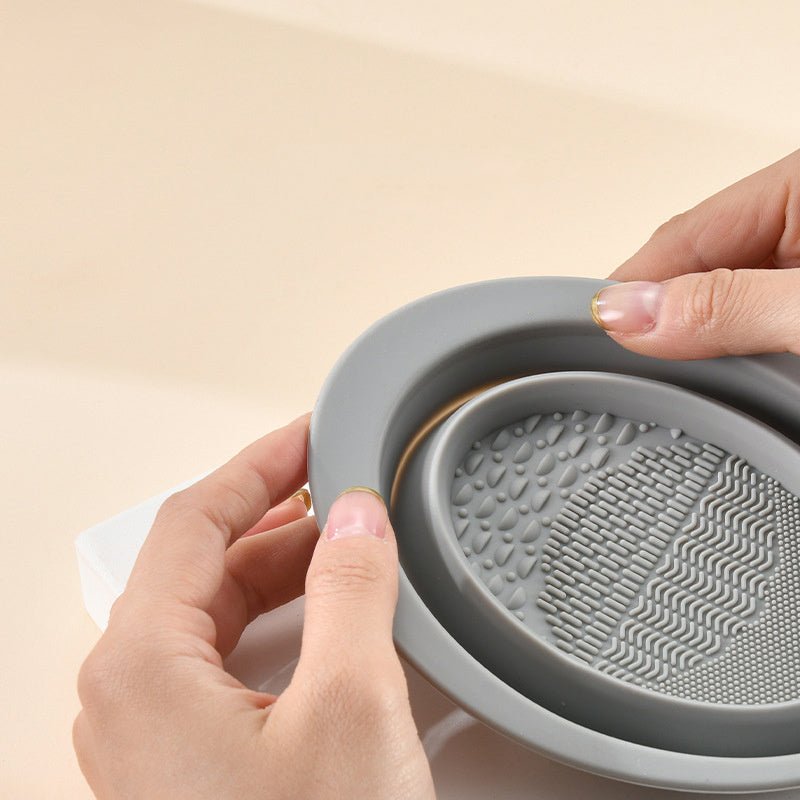 Scrubbing Plate Makeup Brush Cleaning Pad Makeup Brush Cleaning Bowl $24.00 Dana Fashion Color: Dark Purple makeup Product Information Name: Makeup brush folding cleaning bowl Material: Silicone Be applicable: DIY facial mask Brewing water film Soaking be
