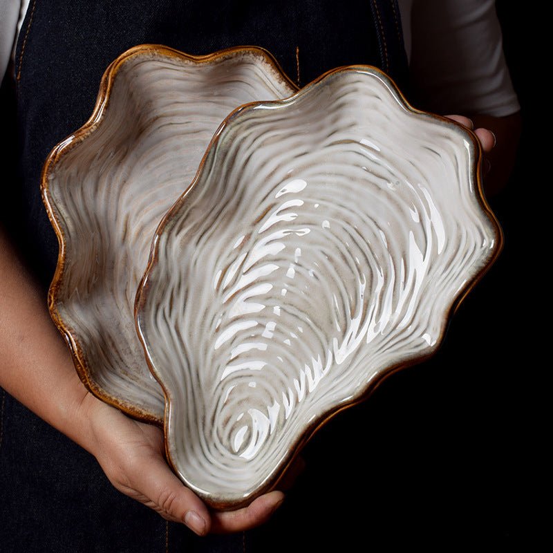 Shaped plate shell plate $38.32 Dana Fashion Color: Dark blue Dana's Kitchen Material: Porcelain Applicable people: adults pattern: plain Style: Japan and South Korea Shape: irregular Microwave oven: available Applicable scene: Hotel, meals, restaurants,