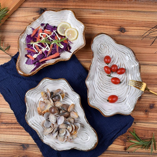 Shaped plate shell plate $38.32 Dana Fashion Color: Dark blue Dana's Kitchen Material: Porcelain Applicable people: adults pattern: plain Style: Japan and South Korea Shape: irregular Microwave oven: available Applicable scene: Hotel, meals, restaurants,