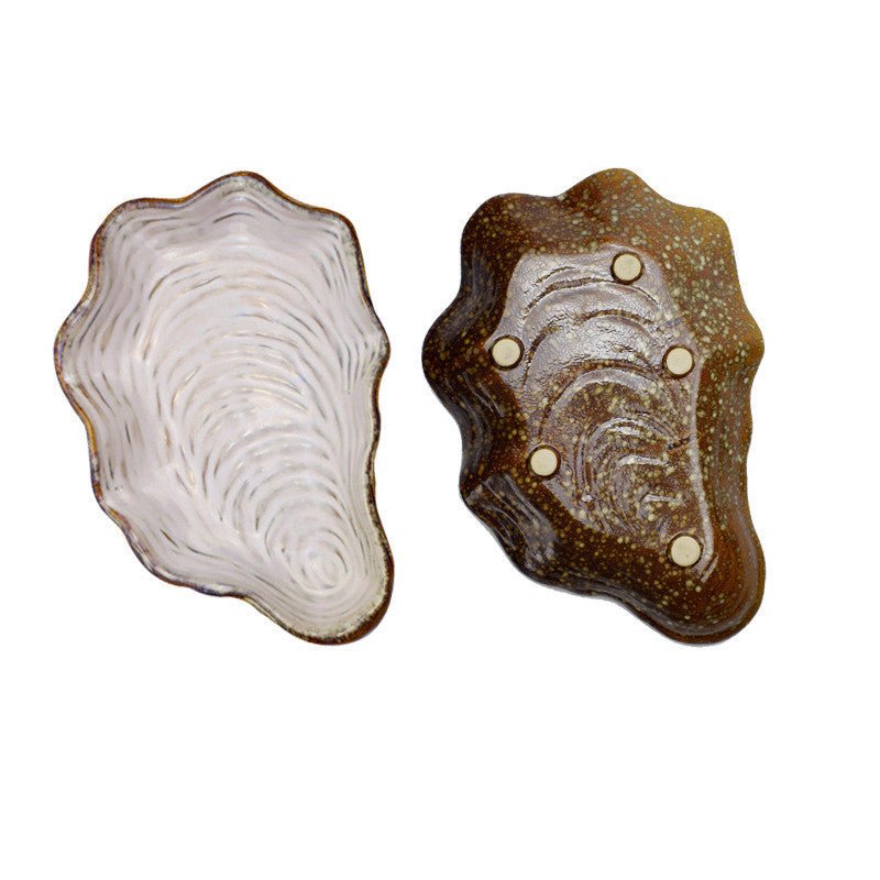 Shaped plate shell plate $38.32 Dana Fashion Color: Pearl Dana's Kitchen Material: Porcelain Applicable people: adults pattern: plain Style: Japan and South Korea Shape: irregular Microwave oven: available Applicable scene: Hotel, meals, restaurants, fami