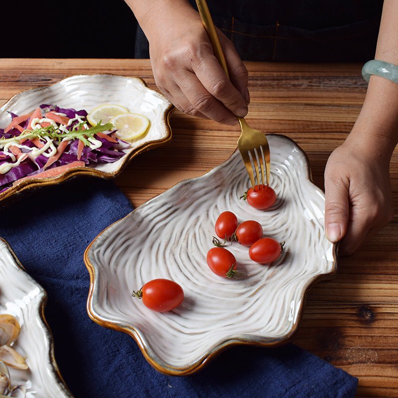 Shaped plate shell plate $38.32 Dana Fashion Color: Dark blue Dana's Kitchen Material: Porcelain Applicable people: adults pattern: plain Style: Japan and South Korea Shape: irregular Microwave oven: available Applicable scene: Hotel, meals, restaurants,