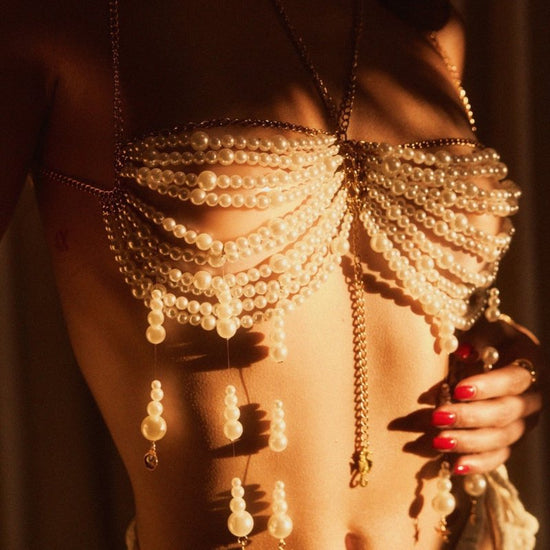 Stringed Pearls Chest Necklace Tassel Halterneck Vest Top Body Chains $39.00 Dana Fashion Color: White Size: Free Size Women's Accessories Product information: Type: pearl beads chest necklace top vest Color: White Style: Women's Material: Alloy Size: fre