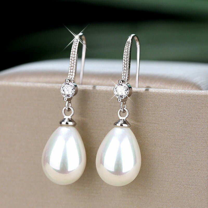 Women's Elegant Drop-shaped Imitation Pearl Long Earrings $8.36 Dana Fashion Color: E1604 White Gold Color Women's Accessories Product information: Treatment Process: pearl inlaid Color: E1604 white gold color Material: Copper Shape: Geometric Packing lis