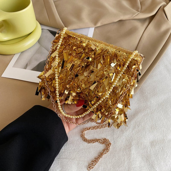 Women's Fashion Retro Sequin Tassel Handbag $63.39 Dana Fashion Color: Gold Women's Bags Product information: Color: white, black, gold, silver, pink Material: acrylic plastic Popular elements: sequins Lining texture: polyester Bag shape: horizontal squar