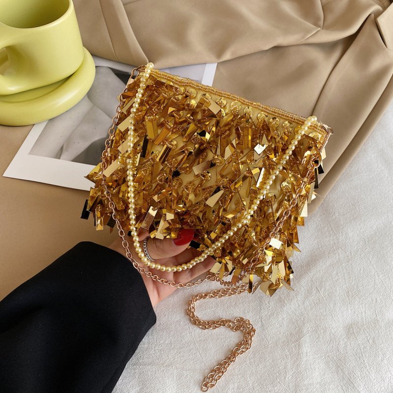 Women's Fashion Retro Sequin Tassel Handbag $63.39 Dana Fashion Color: Gold Women's Bags Product information: Color: white, black, gold, silver, pink Material: acrylic plastic Popular elements: sequins Lining texture: polyester Bag shape: horizontal squar