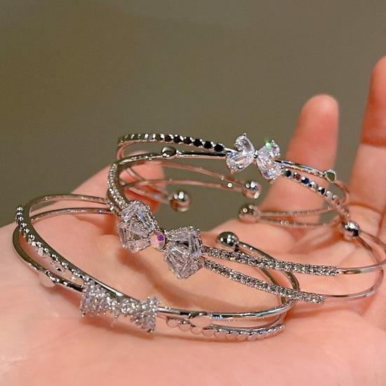 Women's Fashion Silver Niche Bow Bracelet $19.62 Dana Fashion Color: First Model Silver Women's Accessories Product information: Treatment Process: Electroplating Color: First style/silver, Second style/silver, Third style/Silver Material: Copper/zircon S
