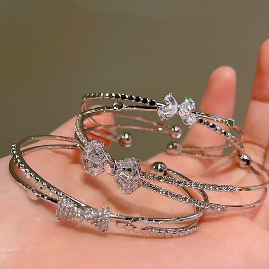 Women's Fashion Silver Niche Bow Bracelet $19.62 Dana Fashion Color: First Model Silver Women's Accessories Product information: Treatment Process: Electroplating Color: First style/silver, Second style/silver, Third style/Silver Material: Copper/zircon S