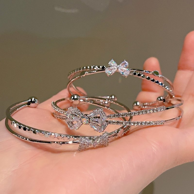 Women's Fashion Silver Niche Bow Bracelet $19.62 Dana Fashion Color: First Model Silver Women's Accessories Product information: Treatment Process: Electroplating Color: First style/silver, Second style/silver, Third style/Silver Material: Copper/zircon S