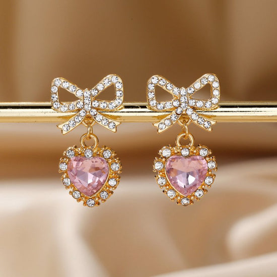 Zinc Alloy Bow Heart Shape With Diamond Earrings $9.84 Dana Fashion Color: Pink Love Heart Women's Accessories Product information: Color: blue loving heart, pink love, Red Love, purple love, Rose Red Love Material: zinc alloy Shape: heart-shaped, Bow Pac