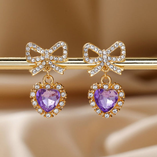 Zinc Alloy Bow Heart Shape With Diamond Earrings $9.84 Dana Fashion Color: Purple Love Women's Accessories Product information: Color: blue loving heart, pink love, Red Love, purple love, Rose Red Love Material: zinc alloy Shape: heart-shaped, Bow Packing